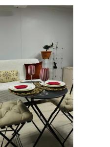 a dining room with a table with plates and chairs at Cheap Quiet Double Room in Park Royal with off-site Gym Access to Showers in London +10 photos
