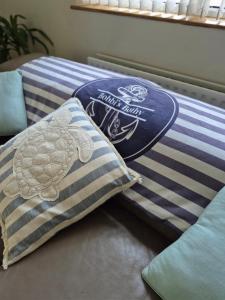 a bed with two pillows and a turtle pillow at Bobbi's Bothy in Newcastle