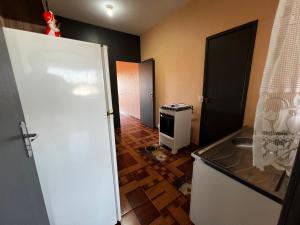 a small kitchen with a sink and a stove at Apto - Brasilândia do Sul - PR in Assis Chateaubriand +5 photos