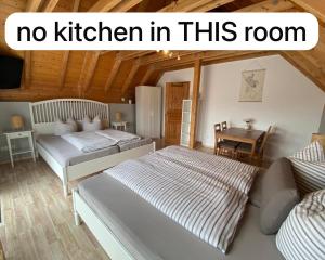 two beds in a room with the words no kitchen in this room at Gästehaus Brigitte Duri in Rust