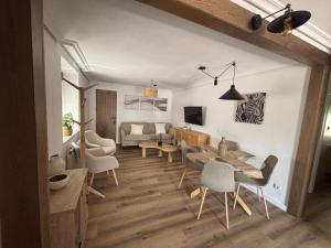 a room with a table and chairs and a living room at El Refugio de los Corrales in San Mateo