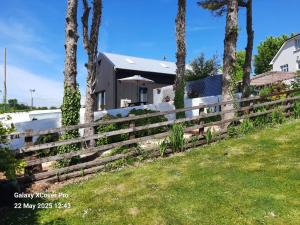 a wooden fence in front of a house at The Rebel Yew in Killala