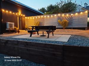 a picnic table in front of a building with lights at The Rebel Yew in Killala