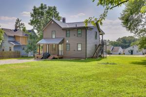 a house with a porch and a yard at 3 Mi to Downtown Youngstown Apt with Deck! in Youngstown