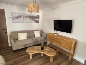 a living room with a couch and a flat screen tv at El Refugio de los Corrales in San Mateo +90 photos