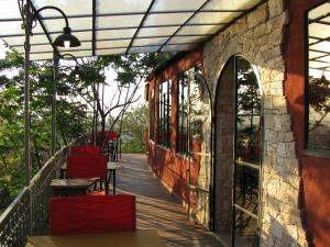 a balcony with red chairs on a building at Belvedere Hotel in Antananarivo