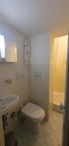 a bathroom with a toilet and a sink at Casetta vacanze a due passi dal mare in Santa Margherita Ligure +4 photos