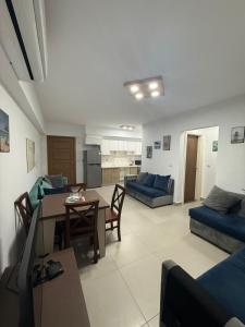 a living room with a table and a dining room at Zafero marassi FOR FAMILIES ONLY NO COUPLE- weekend without sea in El Alamein