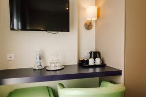 TV a/nebo společenská místnost v ubytování Stella Swiss Quality Hotel