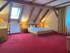 a bedroom with a large bed in a attic at Pension zur Post in Waal +49 photos