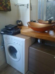 a bathroom with a sink and a washing machine at RaMaya casa d'artista 2 in Biella +27 photos