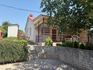 a house with a retaining wall in front of it at Дом у моря in Odesa