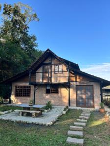 a brick house with a picnic table in front of it at Celeiro Herzland in Pomerode