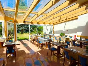 a dining room with wooden tables and chairs at Hotel hArz7 in Seesen