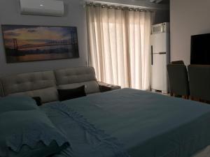 a bedroom with a large bed and a large window at ESTUDIO PANORAMiCO in Florianópolis +6 photos