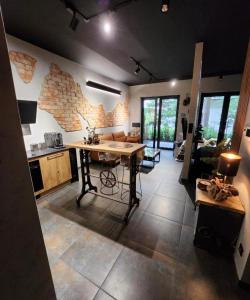 a kitchen with a table in the middle of a room at Luxury River Side apartament, Pool, Gym & Sauna in Kraków
