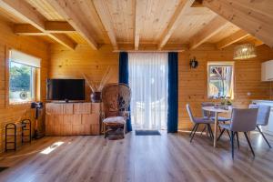 a dining room with a table and chairs and a television at Amara Houses in Rewal