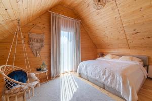 a bedroom with a hammock in a wooden cabin at Amara Houses in Rewal