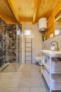 a bathroom with a shower and a sink and a toilet at Amara Houses in Rewal