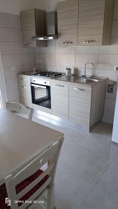 a kitchen with a sink and a stove top oven at La casa di Erica in Sestu