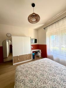 a bedroom with a bed and a white cabinet at Il Bricoccolo in Loreto