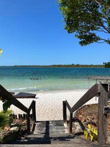 a beach with people swimming in the water at Kza da Paty Preá dEla in Prea