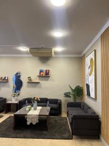a living room with couches and a table in a room at Houres Hotel in Cairo