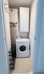 a washer and dryer in a small room at Cannes Palm Beach - Brand New Studio - Oasis of Calm in Cannes