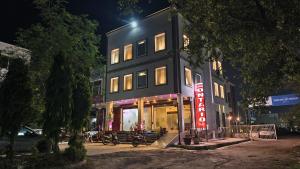 a building with a store front at night at Hotel Ontario in Patiāla