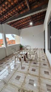 a room with a table and chairs on a tile floor at Casa Amarela no Centro in Barreirinhas