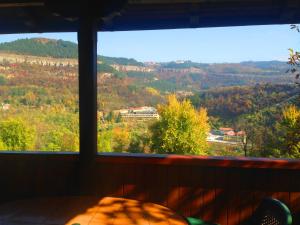 a window in a room with a view of trees at Tipografov View Guest House in Veliko Tŭrnovo