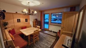 a living room with a couch and a table at Haus Thalgau E14 in Saalbach-Hinterglemm