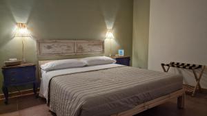 a bedroom with a bed with two lights on the wall at Le case di Papà Nuccio in Pietrabbondante