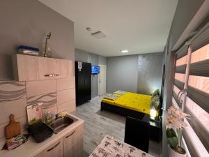 a small room with a yellow bed in the background at Mitić Apartmani 1 in Niš