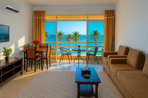 a living room with a couch and a table at Beautiful Salalah Beach Apartments - 1 by Beautiful Salalah Tours in Salalah