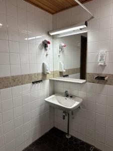 a bathroom with a sink and a mirror at Casual Housing Kemi in Kemi