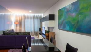 una sala de estar con un sofá y una mesa en Porto H Dragão, en Oporto