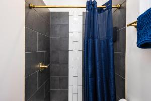 a shower with a blue shower curtain in a bathroom at Arbutus Lake Retreat in Traverse City +32 photos