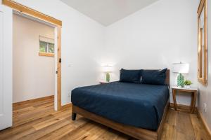 a bedroom with a bed in a white room at Arbutus Lake Retreat in Traverse City