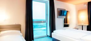 Postel nebo postele na pokoji v ubytování B&B Hotel Bamberg
