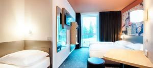 Postel nebo postele na pokoji v ubytování B&B Hotel Bamberg
