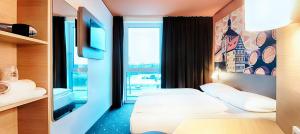 Postel nebo postele na pokoji v ubytování B&B Hotel Bamberg