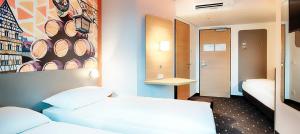 Postel nebo postele na pokoji v ubytování B&B Hotel Bamberg