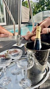 a table with glasses and a bottle of champagne at Brightside Apartment in Kristiansand