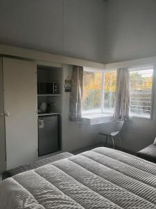 a bedroom with a bed and a window at Peaamb GuestHouse - Springs Golf Club in Springs