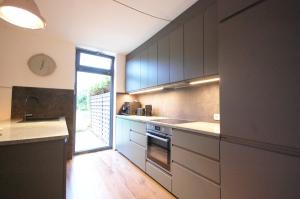 a kitchen with a sink and a stove at Ferienhaus mit Blick über die Felder und Golfplatz in Ratekau +27 photos