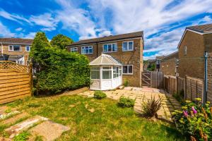 a house with a garden with a gazebo at Family friendly 3-bed home free parking on site in Huddersfield