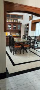 a dining room with a glass table and chairs at Luxury bungalow in Patiāla