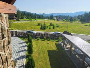 a balcony with a view of a field and a road at Casa 7 Izvoare in Borsec