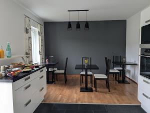 a kitchen and dining room with a table and chairs at Stop & Sleep - Private Rooms in Ybbs an der Donau